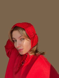 a woman wearing a red hat and scarf