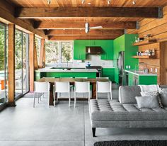 a living room filled with furniture and green walls