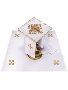 Chalice linen set embroidered with IHS (67H). Chalice linen set made of high-quality fabric, decorated with embroidery with a Eucharistic motif made with gold threads, which depicts the IHS symbol. The set includes four parts: a chalice pall in purple, as well as a corporal, purificator and towel. Thanks to the unifying motif of the Jerusalem Cross, the set forms a coherent whole. Chalice pall - was made of polyester fabric consisting of 100% PE, decorated with embroidery made with gold threads, Elegant Embroidered Linen Sets, Gold Embroidered Sets For Traditional Ceremonies, Ceremonial Gold Sets With Embroidered Border, Gold Sets With Embroidered Border For Traditional Ceremonies, Ihs Symbol, Fibre And Fabric, Linen Set, Gold Threads, Hand Embroidered