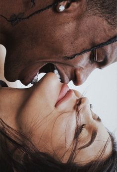 a man kissing a woman's forehead with barbed wire around her neck and nose