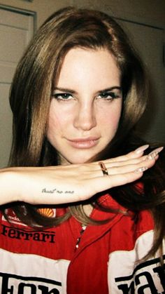 a woman with tattoos on her arm posing for the camera