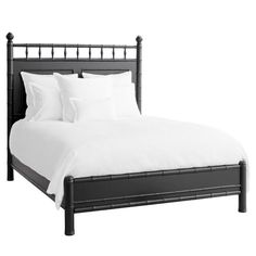 a black bed with white sheets and pillows