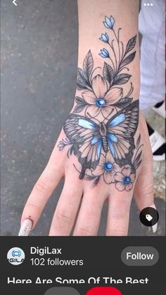 a woman's hand with a blue butterfly tattoo on it and flowers around the wrist