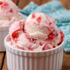 two bowls filled with ice cream on top of a wooden table