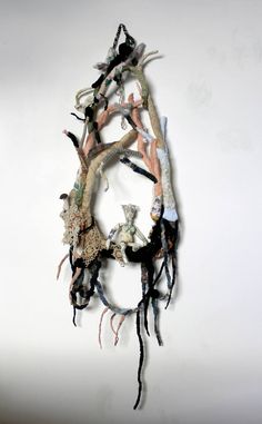 a sculpture made out of various objects on a white wall