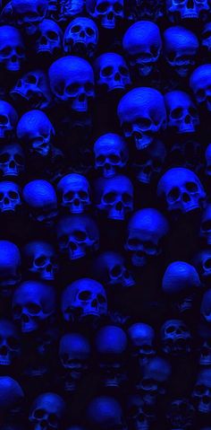 many blue skulls are in the dark