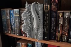 a book shelf filled with lots of books next to a wall covered in bookshelves