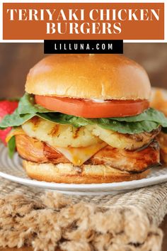 a chicken burger with lettuce, tomato and cheese