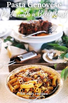 pasta with beef and sauce in a bowl on a table next to other plates, utensils and silverware