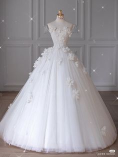 a white wedding dress with flowers on it