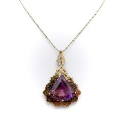 This is part of Chairish’s Fine Jewelry assortment.  A gorgeous modernist Amethyst gemstone pendant set into 14k yellow gold. The pendant takes a triangular drop form, while the hand-sawed details give a snow-flake or organic feel. This is a fine example of natural forms inspiring a more modern, angular design. The amethyst has a lovely saturated purple colour, and its size is impressive. The amethyst in a six prong setting has an open back to let light in; the gem reflects and retracts light in Pear-shaped Amethyst Jewelry In Yellow Gold, Yellow Gold Pear-shaped Amethyst Jewelry, Yellow Gold Amethyst Teardrop Pendant Jewelry, Art Deco Amethyst Jewelry In Yellow Gold, Art Deco Amethyst Yellow Gold Jewelry, Amethyst Pendant Necklace, Angular Design, Amethyst Necklace Pendant, Snow Flake