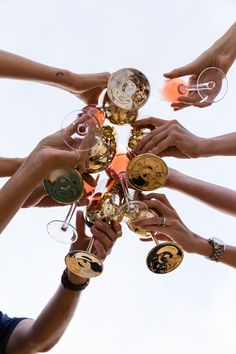 a group of people holding wine glasses in the air