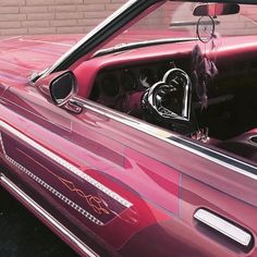 the interior of a pink convertible car is shown