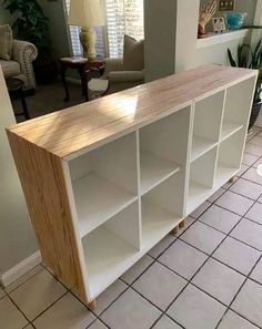 a white bookcase sitting on top of a tiled floor