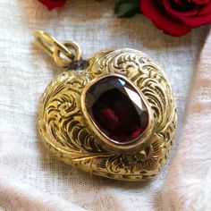 Antique Garnet Heart Locket Introducing our exquisite antique 14K chased gold heart locket, a timeless piece.  Adorned with a captivating red garnet on the front, this elegant locket combines vintage charm with a touch of romance.  Keep cherished memories close to your heart in this meticulously crafted accessory that whispers tales of a bygone era. Antique Heart Locket, Heirloom Oval Jewelry For Valentine's Day, Elegant Medallion Locket Necklace For Valentine's Day, Heirloom Jewelry For Valentine's Day, Victorian Medallion Jewelry With Heart Charm, Victorian 14k Gold Jewelry For Valentine's Day, Formal Heart-shaped Locket Jewelry, Formal Heart Shaped Locket Jewelry, Heart Locket For Formal Occasions