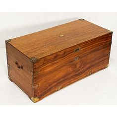 an old wooden box sitting on top of a white table