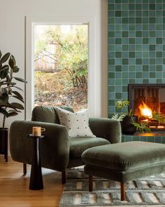 a living room filled with furniture and a fire place next to a wall mounted fireplace