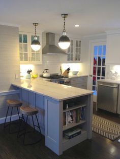 a kitchen with an island and two stools