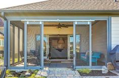 an enclosed patio with sliding glass doors leading to the back yard and covered porch area