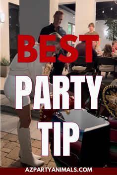 a woman in white dress and cowboy boots standing next to a table with people sitting around it