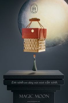 an image of a hot air balloon floating on top of two books with the moon in the background