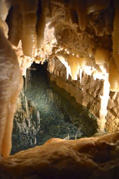 the inside of a cave with water and rocks