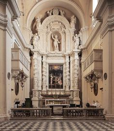 the interior of an old church with black and white checkered flooring on the ground