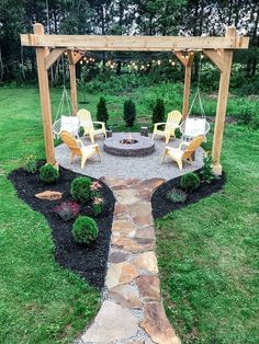 an outdoor fire pit surrounded by lawn furniture and string lights, with chairs around it