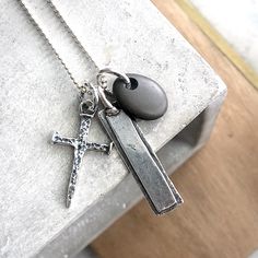 "Artisan Collection of Pendants...Great Father's Day Gift or gift for any man in your life. ~Rustic Hammered artisan-made solid sterling silver cross; made by process of lost wax casting ~Cross is approx 1 1/2\" long (includes attached ring) x 3/4\" wide. ~Artisan Sterling Silver Bar Pendant; can be Personalized with your choice of hand-stamped initials, date, name...etc ~smooth tumbled stone charm (each will vary as they are uniquely different) ~Suspended on Sterling Silver Ball Chain ~All meta Handmade Adjustable Crucifix Jewelry, Spiritual Crucifix Necklace For Memorial, Adjustable Spiritual Cross Necklace, Artisan Cross Pendant Necklace As Gift, Spiritual Cross Jewelry For Father's Day, Handmade Cross Jewelry For Memorial, Artisan Crucifix Necklace For Gift, Artisan Cross Necklace For Gift, Silver Bar