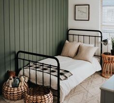 a bed sitting in a bedroom next to a wall with green paint on the walls