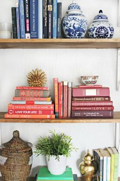 books and vases are sitting on the shelves