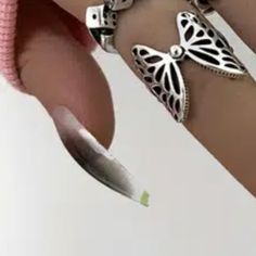 a close up of a person's arm with two butterfly bracelets on it