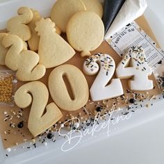 some cookies that have been cut into the shape of numbers and are sitting on a table