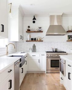 the kitchen is clean and ready for us to use it's white cabinets, wood floors, and stainless steel appliances