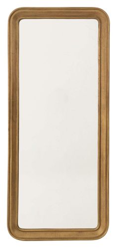 a gold framed mirror sitting on top of a white wall