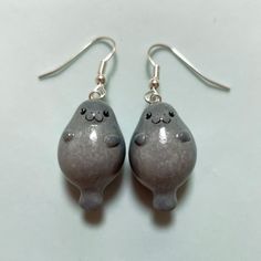 two gray ceramic animal shaped earrings with silver earwires