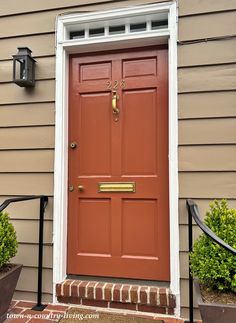 a red front door on a brown house