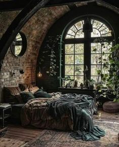 a bedroom with an arched window in the middle and lots of plants on the wall