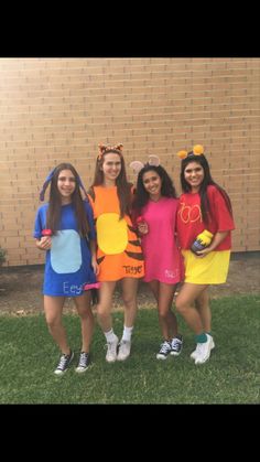 three girls dressed up as winnie the pooh and tigger