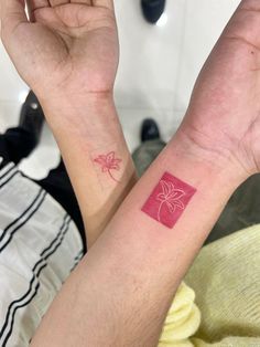 two people with matching tattoos on their arms