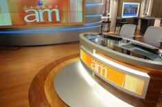 an empty tv studio with chairs and desks