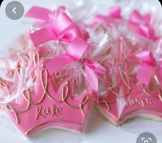 two decorated cookies with pink bows on them