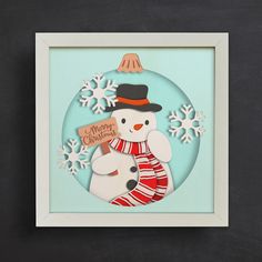 an ornament with a snowman holding a sign