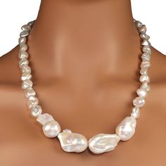 23-Inch statement necklace of white chinese freshwater pearls, 12 x12mm, with four focal large white baroque pearls approximately 28-30mm at the front of the necklace. All of these magnificent pearls are iridescent. This 23-inch necklace is secured with a silver plate two ring a toggle clasp. MN2398 Luxury Silver Pearl Necklace With Polished Beads, Luxury Refined Round Pearl Necklace, Pearl Statement Necklace, John Galliano, Donna Karan, Toggle Clasp, Baroque Pearls, Jewelry Lover, White Pearl