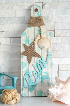 a wooden sign that says relax with shells and seashells