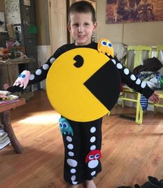 a young boy is dressed up as pacman