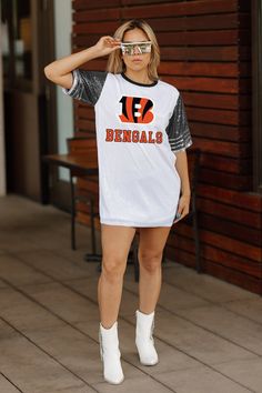 Elevate your game day look with our Cincinnati Bengals full sequin jersey tunic dress. Designed with sports striping details on the sleeves and a lightweight garment lining, it ensures both style and comfort. Whether you're cheering from the stands or watching from home, rock your favorite school or team in standout fashion. Nfl Fashion, Football Jersey Dress, Football Fashion, Gameday Outfit, Cincinnati Bengals, Football Jerseys, Jersey Dress, Tunic Dress, Cincinnati