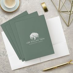 the willow tree logo is displayed on top of three folded cards next to a cup of coffee