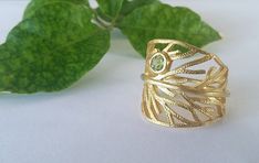 This elegant Leaf Ring is Hand Crafted from Gold Plated Sterling Silver 925, and a Peridot Stone. Inspired by Nature, this Leaf Ring, is suitable for everyday use & any occasion.  This is a great gift for nature lovers! You will receive it in a beautiful package ready for gift giving! *For longer life of jewelry, avoid contact with water ,body lotions , perfumes etc. Nature-inspired Peridot Rings As Gift, Chrysocolla Ring, Silver Leaf Ring, Triangle Ring, Blue Stone Ring, Peridot Stone, Leaf Ring, Unique Birthday Gifts, Gifts For Nature Lovers