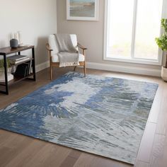 a living room with a chair and rug in front of a large window on the floor